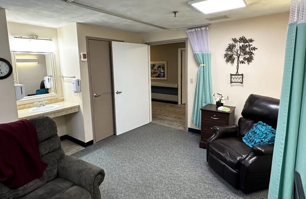 Cozy private resident room with armchair and bathroom
