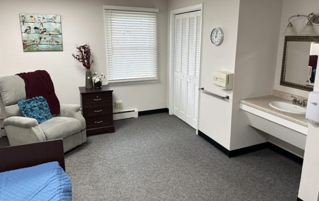 Cozy resident room with a chair and dresser