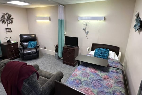 Cozy private resident room with a bed and seating