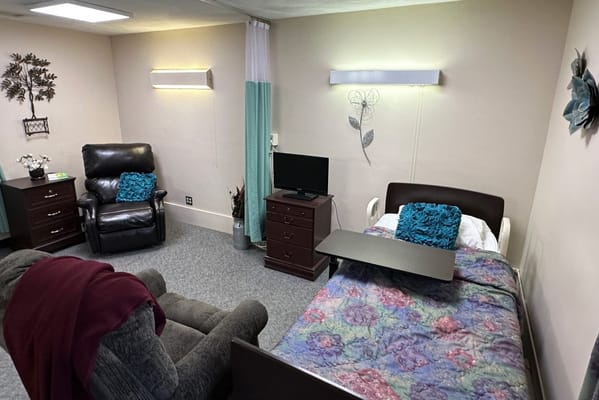 Cozy private resident room with a bed and seating