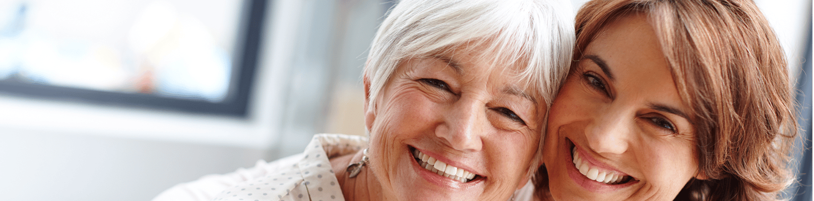 Two smiling women enjoying a moment together