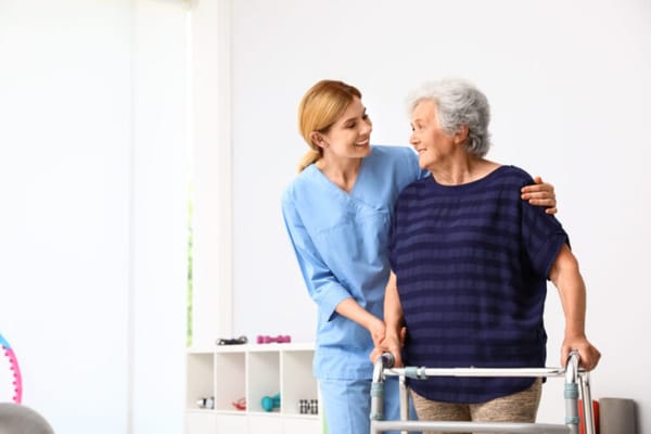 Caregiver assisting a resident with a walker