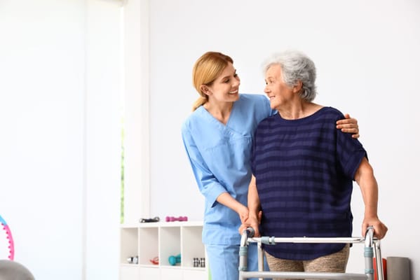 Caregiver assisting a resident with a walker