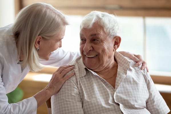 A caregiver and a resident sharing a joyful moment
