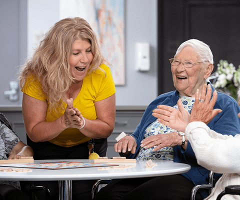 Residents enjoying a group activity with staff support
