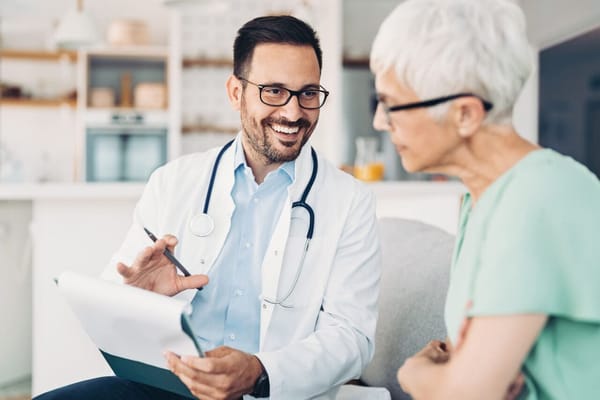 A healthcare professional consulting with a senior resident