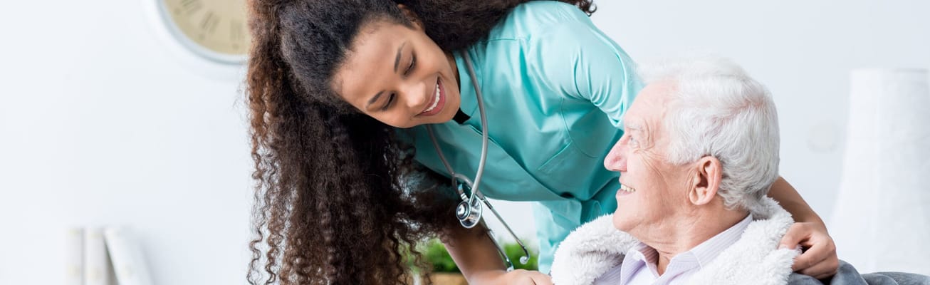 Caregiver interacting joyfully with a senior resident