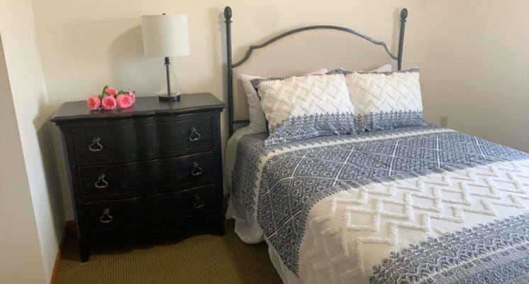 Cozy resident room with a bed and dresser