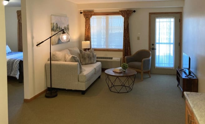 Cozy living area with a couch and a door to the outside