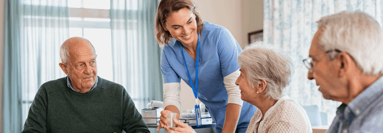 Staff assisting residents in an interior setting