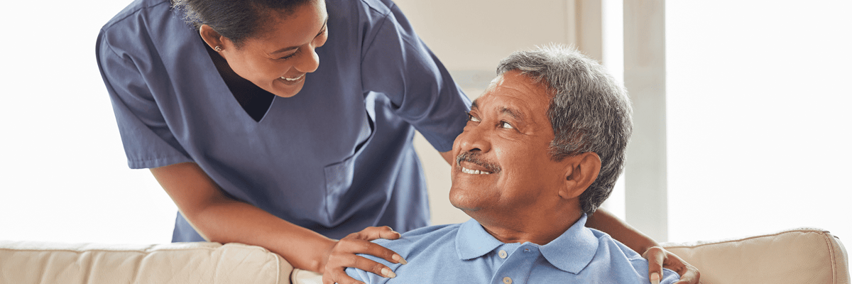 Nurse interacting with a smiling resident