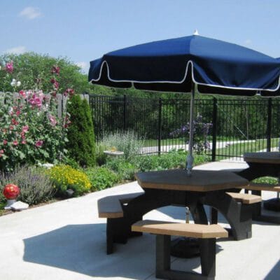 Outdoor seating area with flowers and a large umbrella