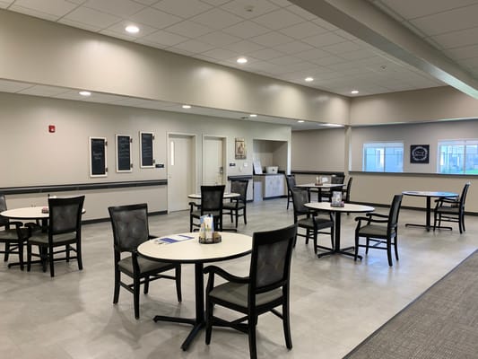Bright common area with dining tables and chairs