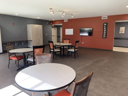 A bright common area with tables and chairs