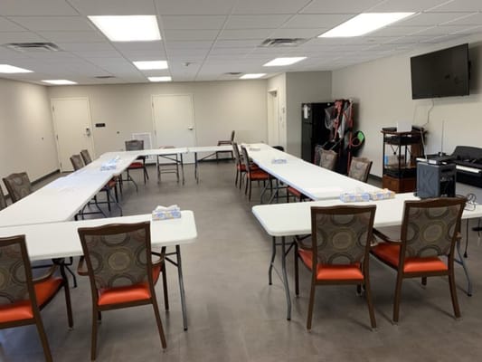 Activity room set up with tables and chairs