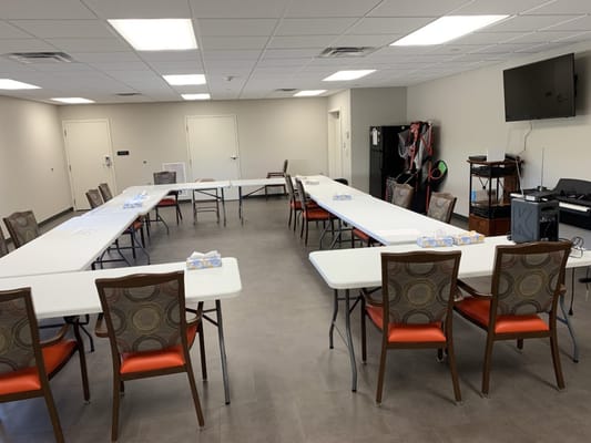 Activity room set up with tables and chairs