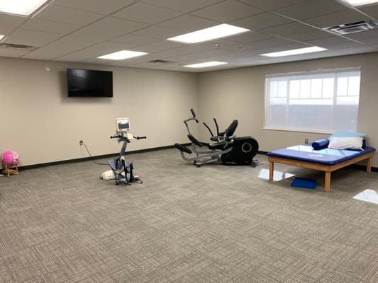 Exercise equipment in a therapy room with natural light