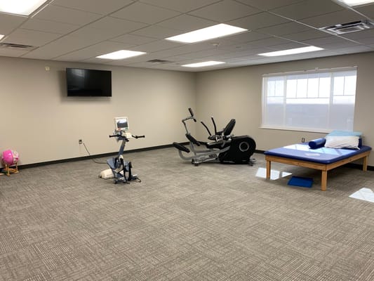 Exercise equipment in a therapy room with natural light
