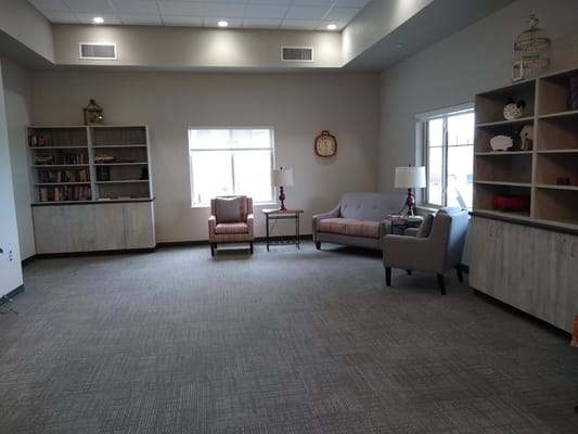 Cozy common area with seating and bookshelves