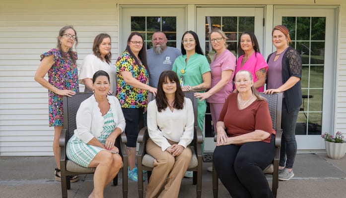 Staff members posing outdoors at the facility