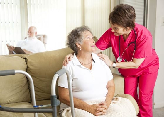 Nurse assisting a resident in a cozy common area