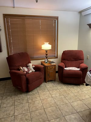 Cozy seating area with recliners and toys