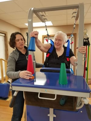 Resident participating in an activity with staff assistance