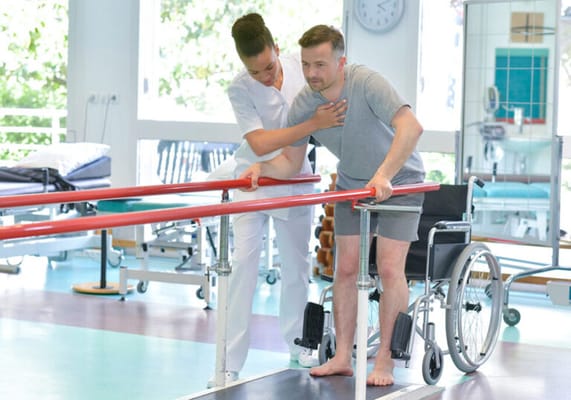 A resident receiving assistance during physical therapy