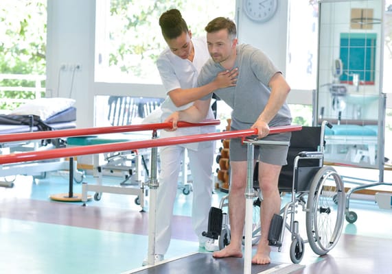 A resident receiving assistance during physical therapy