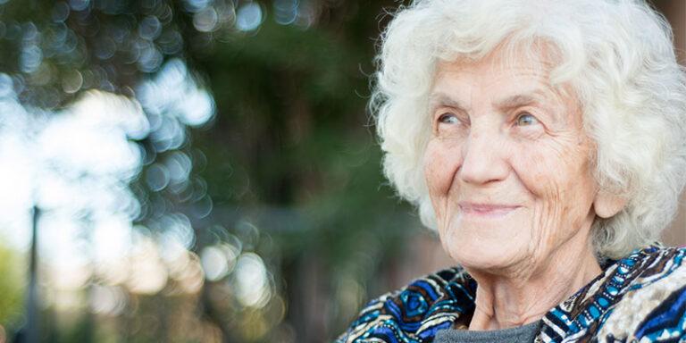 Close-up portrait of an elderly woman smiling