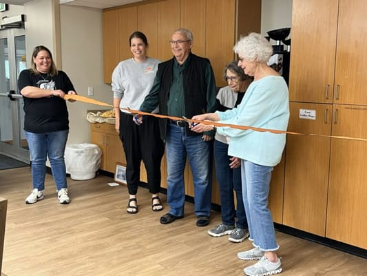 Residents participating in a ribbon-cutting ceremony