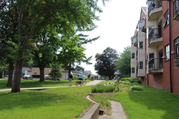 Residents walking on a pathway near the building