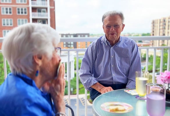 Residents enjoying a meal on a balcony