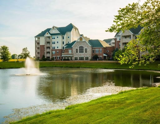 Exterior view of assisted living facility near a pond
