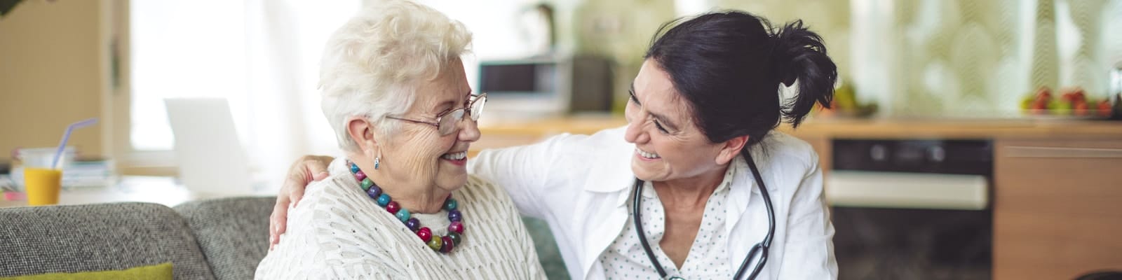 Caregiver interacting warmly with a senior resident