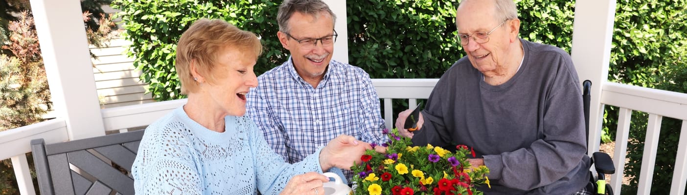 Residents enjoying gardening on a sunny patio