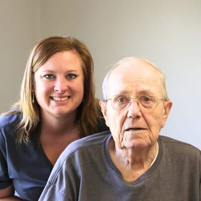 Staff member with resident in a bright common area