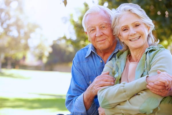 Elderly couple enjoying a sunny day in a garden