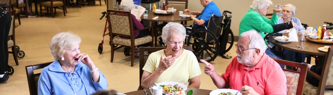 Residents enjoying a meal together in the dining room