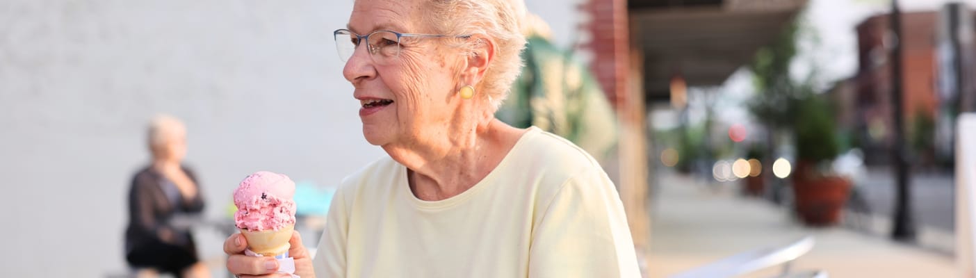 Senior woman enjoying ice cream in an outdoor space
