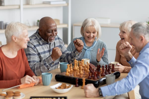 Residents enjoying a game of chess in the activity room