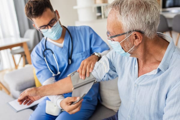 Healthcare worker checking blood pressure of a resident