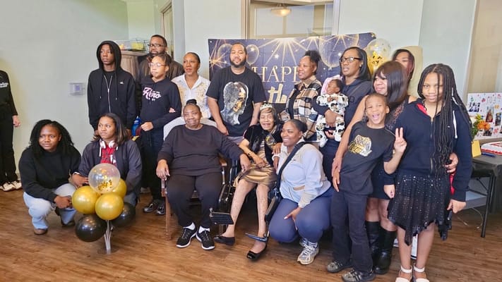 Residents and family gathering for a celebration indoors