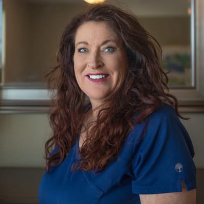 A smiling staff member in a facility interior