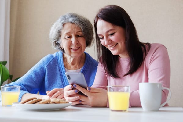 Residents sharing a joyful moment with cookies and juice
