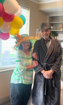 Residents celebrating with balloons in an activity room