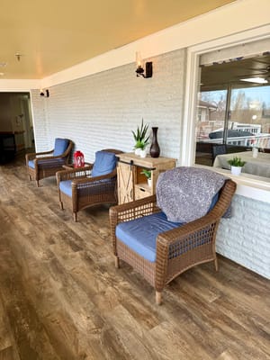 Seating area with chairs and decorative plants in a hallway