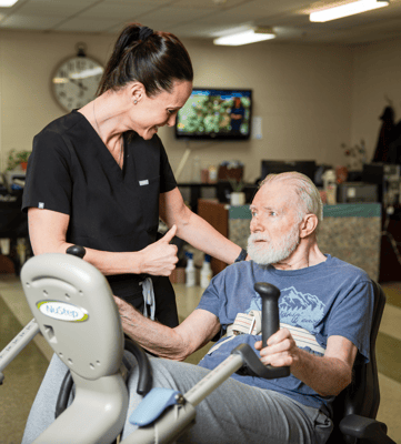 A caregiver assisting a resident in a therapy session