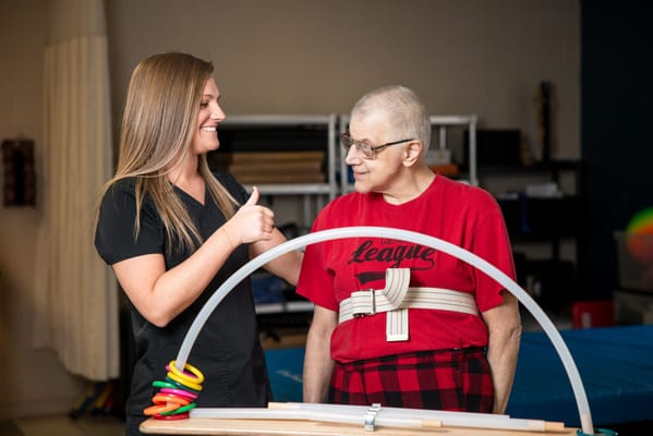 Resident participating in an activity with staff