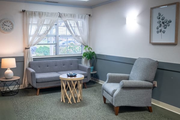 Cozy lounge area with seating and a plant